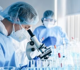 Biochemical,Research,Scientist,Team,Working,With,Microscope,For,Coronavirus,Vaccine